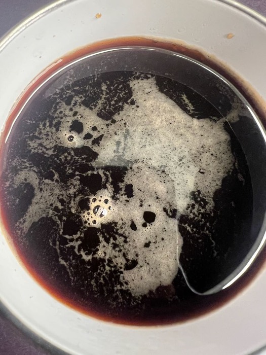 Top-down view of black coffee in a bowl at Black Coffee Cafe